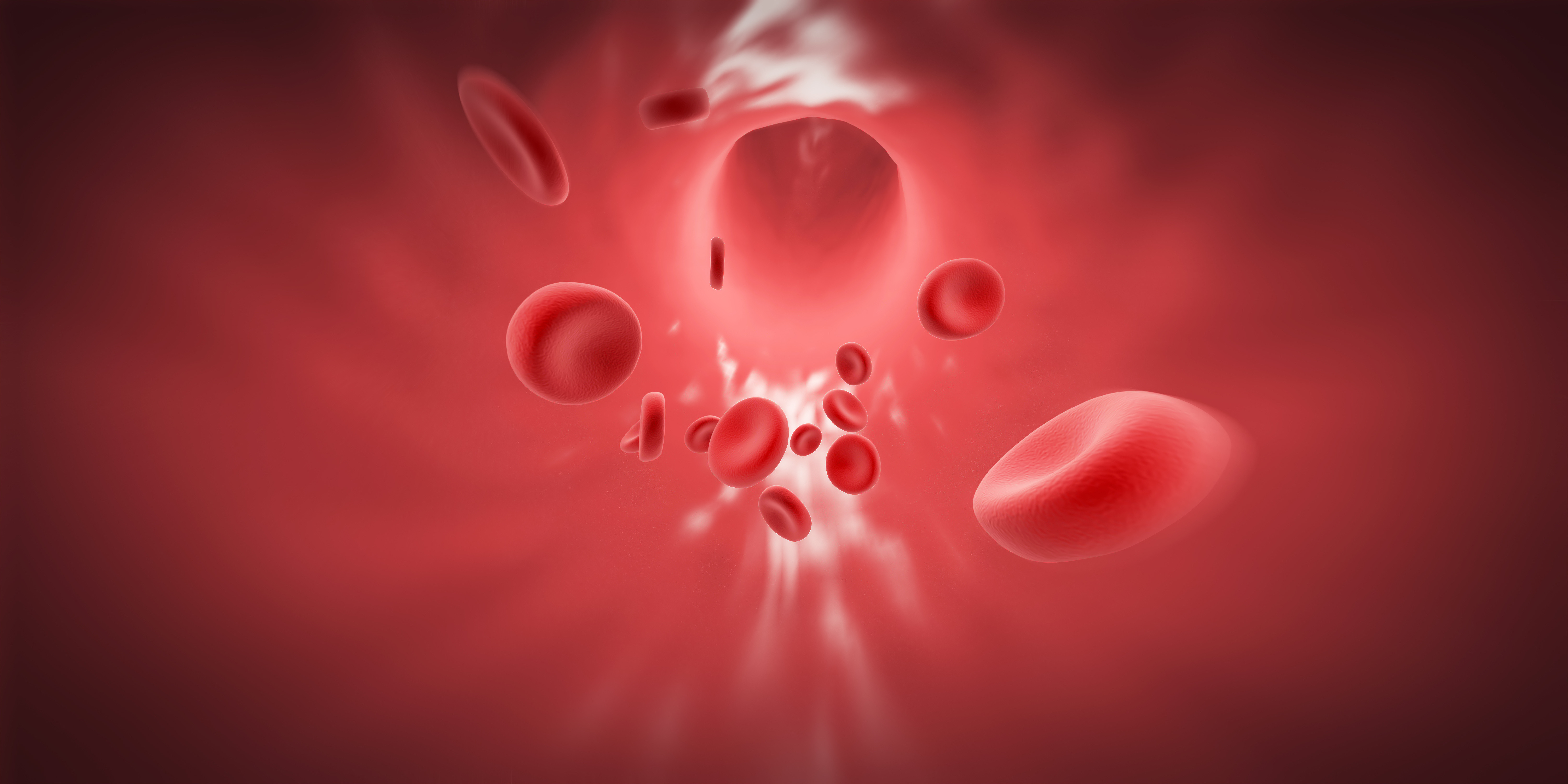 Red blood cells rushing through a blood vessel